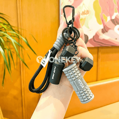 Mini fitnes açarlik — sport görnüşli bezegli sowgat